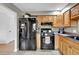 Spacious kitchen showcasing stainless steel appliances and wood cabinetry at 4262 E Fremont Pl, Centennial, CO 80122