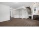 Spacious basement area with neutral carpet, white walls, and stair access, ready for customization at 19096 E 55Th Ave, Denver, CO 80249