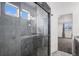Stylish bathroom features a glass-enclosed shower, dual sinks, and modern fixtures, adding a touch of luxury to everyday living at 19096 E 55Th Ave, Denver, CO 80249