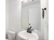Clean bathroom featuring a pedestal sink, modern faucet, and a well-lit mirror, creating a functional space at 19096 E 55Th Ave, Denver, CO 80249