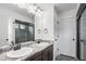 The modern bathroom boasts double sinks, granite countertops, and a tiled shower, providing both style and functionality at 19096 E 55Th Ave, Denver, CO 80249