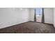 Spacious bedroom with plush neutral carpet, white walls and a large window, creating a blank canvas for decorating at 19096 E 55Th Ave, Denver, CO 80249