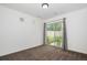 Bright bedroom with sliding glass door, neutral carpet and walls offering a blank canvas for personalization at 19096 E 55Th Ave, Denver, CO 80249
