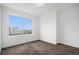 Bedroom with neutral carpet and white walls offers a large window for natural light, creating a clean and inviting space at 19096 E 55Th Ave, Denver, CO 80249