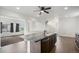 View of the island kitchen and open view into the living room and staircase at 19096 E 55Th Ave, Denver, CO 80249
