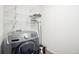 Well-organized laundry room with Samsung washer and wire shelving for efficient storage solutions at 19096 E 55Th Ave, Denver, CO 80249