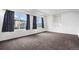 Large room with large windows and plush neutral carpet at 19096 E 55Th Ave, Denver, CO 80249