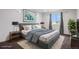 Staged bedroom with plush bedding, stylish lamps, neutral colors, and side tables offering a cozy, inviting atmosphere at 19096 E 55Th Ave, Denver, CO 80249