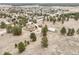 Expansive aerial view of a charming residence, complemented by a red barn and generous acreage at 512 County Road 136, Elizabeth, CO 80107