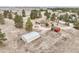 Wide aerial shot of property with large shed, red barn, and a house on grassy open land at 512 County Road 136, Elizabeth, CO 80107