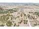Panoramic aerial view of land featuring scattered residences, a red barn, and natural foliage at 512 County Road 136, Elizabeth, CO 80107
