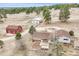 Aerial view of property showcasing a home with a barn and additional garage/workshop buildings at 512 County Road 136, Elizabeth, CO 80107
