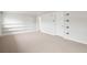Spacious basement area with neutral carpet, white walls, and built in shelves at 512 County Road 136, Elizabeth, CO 80107