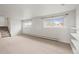 Large basement area with carpet and several windows providing natural light and backyard views at 512 County Road 136, Elizabeth, CO 80107