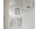 Classic bathroom with a pedestal sink, framed mirror and classic fixtures at 512 County Road 136, Elizabeth, CO 80107