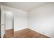 Neutral bedroom with hardwood floors with access to an ensuite bathroom at 512 County Road 136, Elizabeth, CO 80107