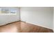 Empty bedroom featuring hardwood floors and a large window at 512 County Road 136, Elizabeth, CO 80107