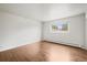 Empty bedroom featuring hardwood floors and a large window at 512 County Road 136, Elizabeth, CO 80107