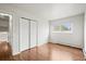 Bright bedroom with wood floors, closet, and natural light from a window at 512 County Road 136, Elizabeth, CO 80107