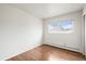 Bright bedroom with hardwood floors and a window providing natural light and outdoor views at 512 County Road 136, Elizabeth, CO 80107
