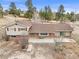 Charming home featuring a spacious deck, appealing brick accents, and beautiful views of the surrounding landscape at 512 County Road 136, Elizabeth, CO 80107