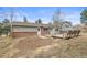 Front exterior view of a charming house with a brick foundation, siding, and a small front yard at 512 County Road 136, Elizabeth, CO 80107