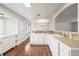 Bright, cozy kitchen features white cabinetry, tiled backsplash, and hardwood floors at 512 County Road 136, Elizabeth, CO 80107