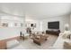 Bright living room featuring wood floors, neutral paint, modern furniture and an open concept dining area at 512 County Road 136, Elizabeth, CO 80107