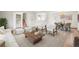 Cozy living room features stylish furniture, plush rug, and a view of the staircase and dining area at 512 County Road 136, Elizabeth, CO 80107