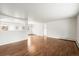 Hardwood floors shine through this living room with a chandelier and an open floorplan at 512 County Road 136, Elizabeth, CO 80107