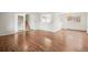 Expansive living room with hardwood floors, neutral paint, and an open layout connecting to the dining area at 512 County Road 136, Elizabeth, CO 80107