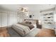 Well-lit main bedroom with ceiling fan, neutral decor, built-in bookshelves and dual closets at 512 County Road 136, Elizabeth, CO 80107