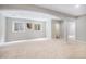 Finished basement space with neutral carpeting, two windows, and a doorway at 529 Uinta Way, Denver, CO 80230