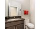 Powder room featuring a granite countertop, dark wood cabinets, and Disney themed hand towels at 529 Uinta Way, Denver, CO 80230