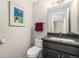 Bathroom featuring a modern vanity with a dark countertop and a red accent towel at 529 Uinta Way, Denver, CO 80230