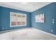 Bedroom with a tray ceiling, a neutral carpet, and a large window providing natural light at 529 Uinta Way, Denver, CO 80230