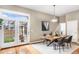 Dining room with hardwood floors, pendant lighting, table with seating for six, and access to the backyard at 529 Uinta Way, Denver, CO 80230