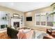 Cozy living room with a fireplace, built-in shelves, hardwood floors, and large windows at 529 Uinta Way, Denver, CO 80230