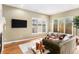 Sun-filled living room featuring hardwood floors, large windows, and stylish furnishings at 529 Uinta Way, Denver, CO 80230