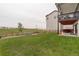 A spacious backyard with green lawn and a patio area, featuring a hot tub and plenty of room for outdoor living at 39405 Stockton Cir, Elizabeth, CO 80107