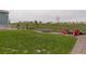 Expansive backyard featuring a lush lawn, open space, a trampoline, and a cozy fire pit area for outdoor enjoyment at 39405 Stockton Cir, Elizabeth, CO 80107