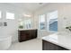 Bright bathroom featuring a double sink vanity with quartz countertops, and modern fixtures at 39405 Stockton Cir, Elizabeth, CO 80107