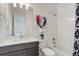 Bathroom featuring a vanity with quartz countertops, and a shower with a rainfall shower head at 39405 Stockton Cir, Elizabeth, CO 80107