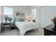 Cozy bedroom with white comforter, desk, and ensuite bathroom at 39405 Stockton Cir, Elizabeth, CO 80107