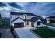 Striking two-story modern farmhouse featuring a black roof, white siding, and a three-car garage at 39405 Stockton Cir, Elizabeth, CO 80107