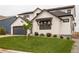 Stylish home featuring a two-car garage, well-kept lawn, and dark trim at 39405 Stockton Cir, Elizabeth, CO 80107