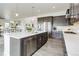 Modern kitchen featuring stainless steel appliances, an island, and a view of the dining area at 39405 Stockton Cir, Elizabeth, CO 80107