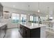 Open-concept kitchen featuring a large island with sink and a clear view to the dining area at 39405 Stockton Cir, Elizabeth, CO 80107