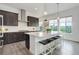Modern kitchen featuring a central island, stainless appliances, and stylish lighting at 39405 Stockton Cir, Elizabeth, CO 80107