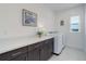 Clean laundry room with washer, dryer, cabinets, and a long countertop for folding at 39405 Stockton Cir, Elizabeth, CO 80107